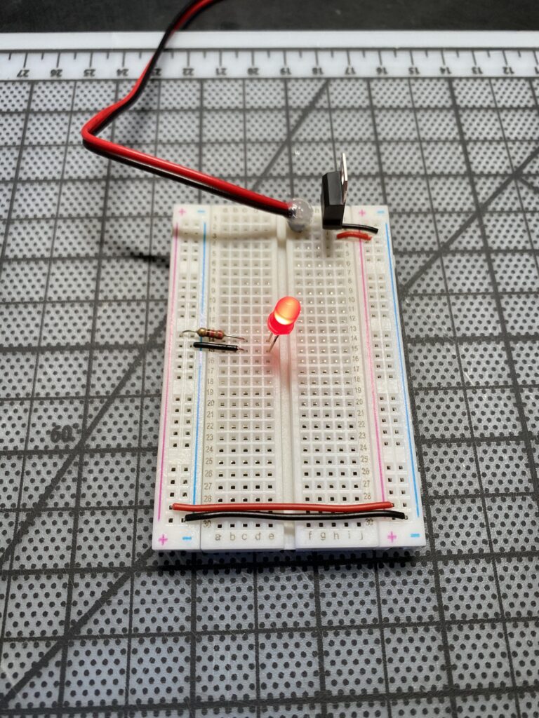 Red LED lit on a breadboard