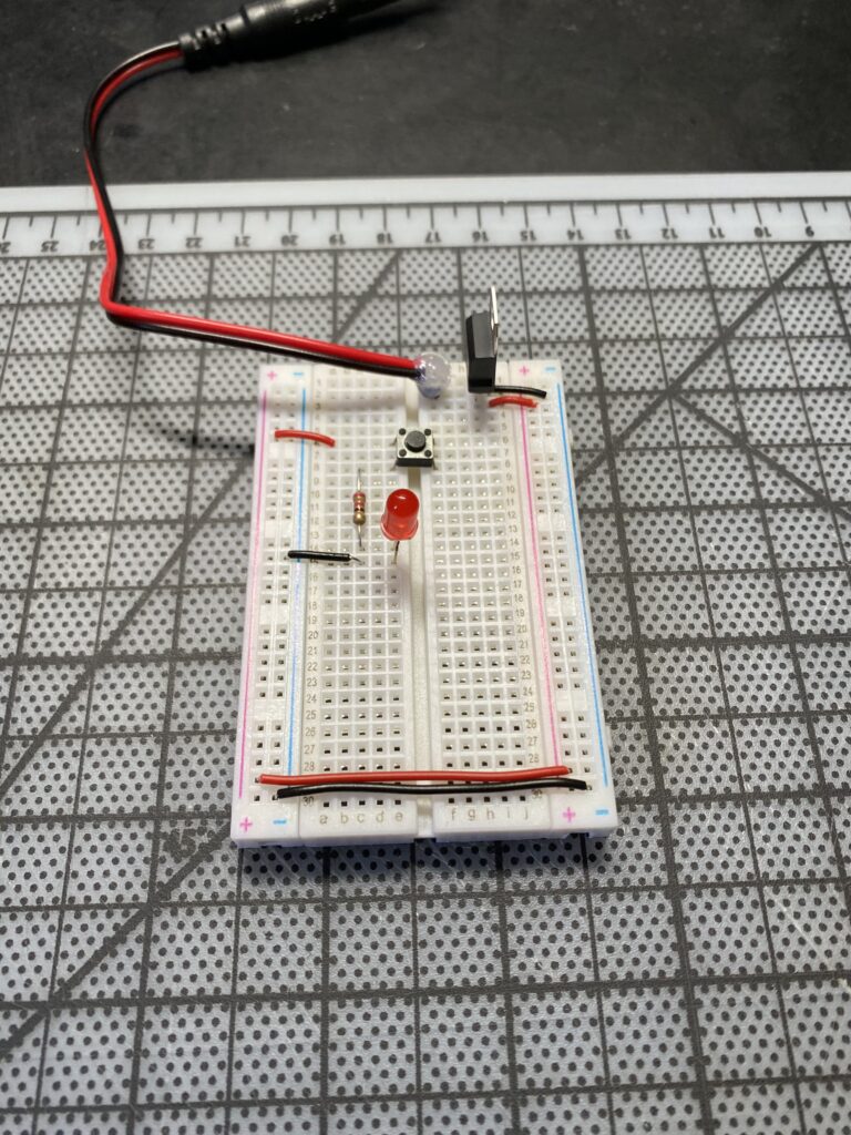 Breadboard with red LED and pushbutton