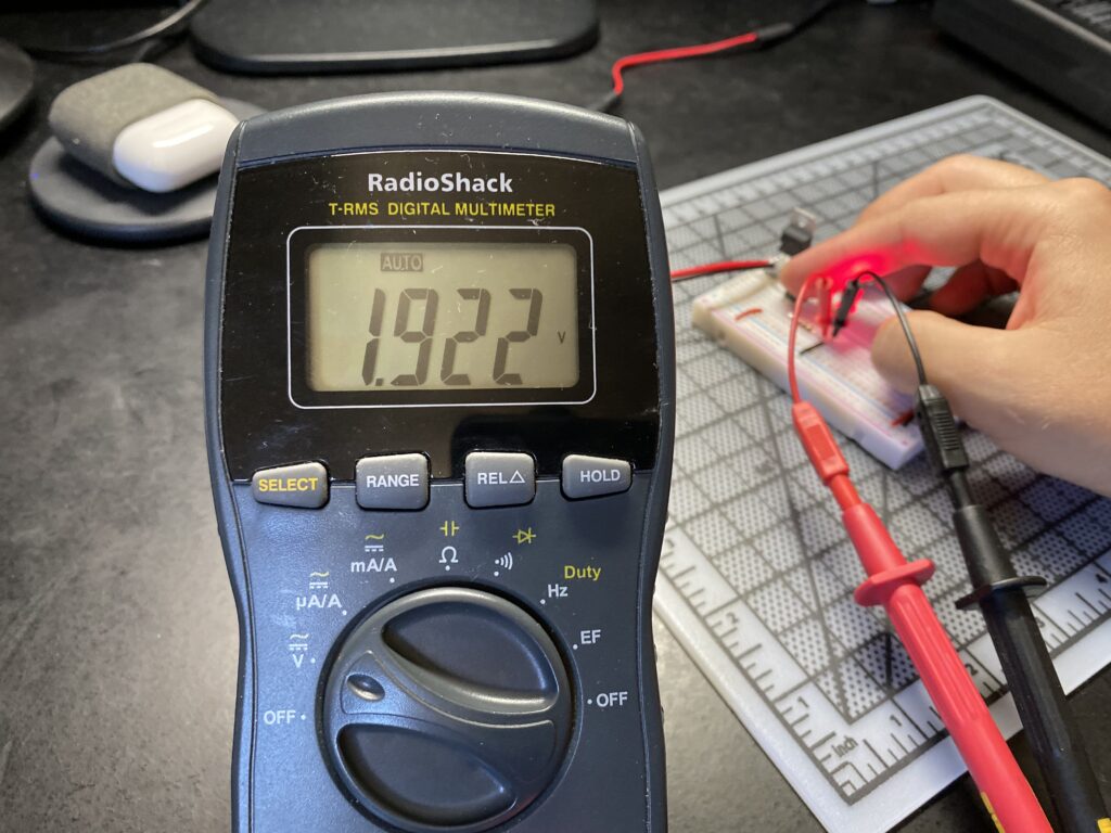 Multimeter reading 1.922 volts voltage drop across a red LED