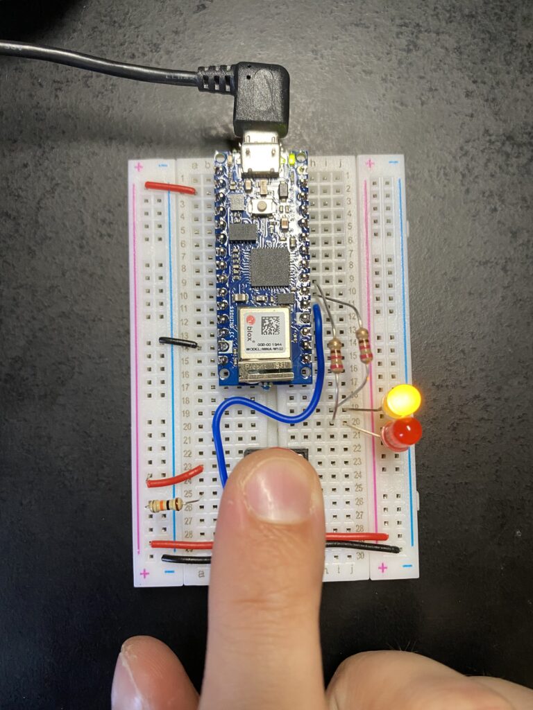 Pressing button triggers yellow LED and turns off red LED