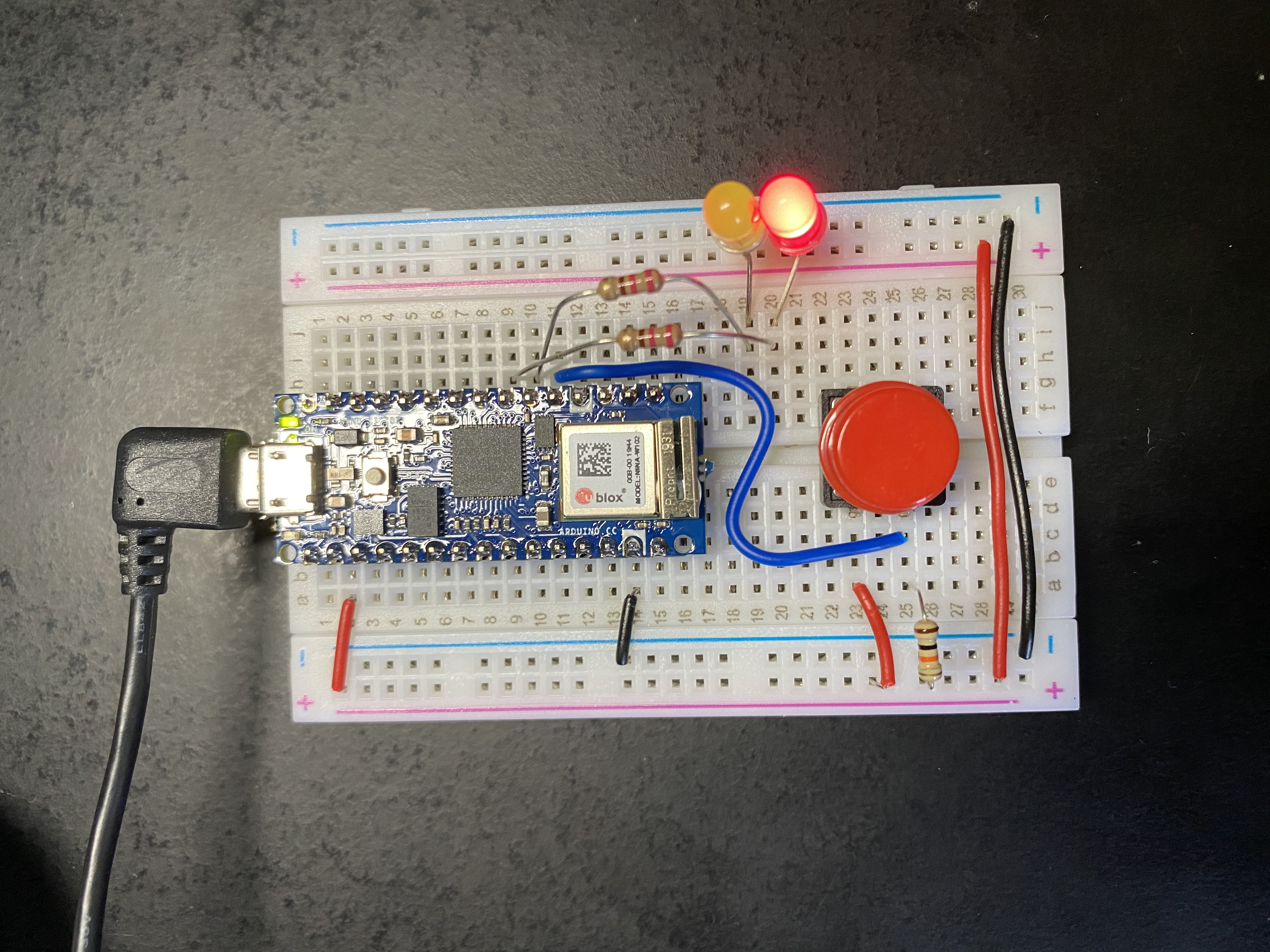 Arduino Nano on breadboard with lit red LED