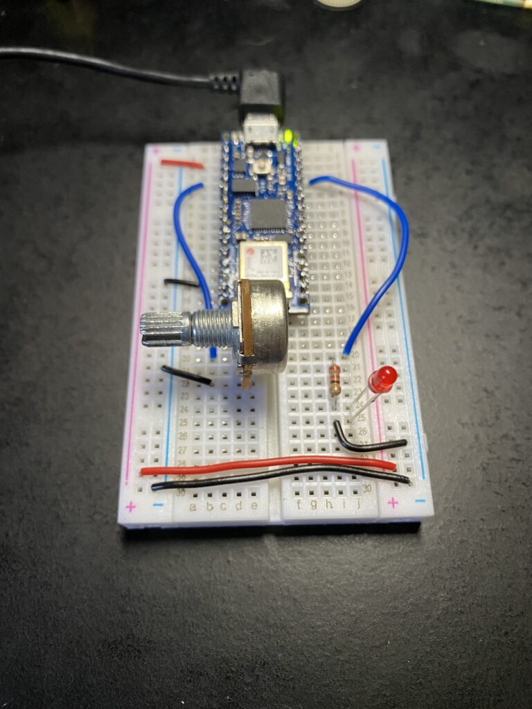 Arduino nano on breadboard with potentiometer and red LED