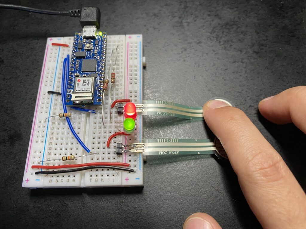 Touching one sensor increases brightness of red LED